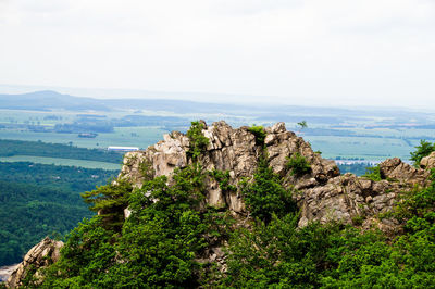 Scenic view of cliff by sea against sky