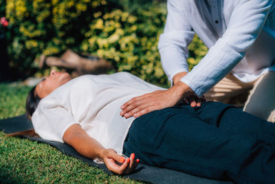 Reiki healing treatment. a therapist is performing a reiki energy healing treatment holding hands 