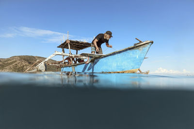 Male surfer in a boat