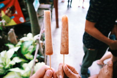 Midsection of person holding ice cream