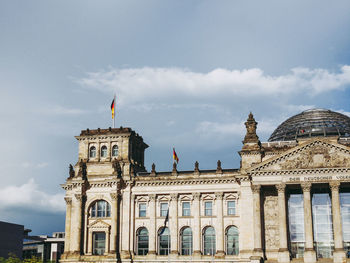 Low angle view of historical building against cloudy sky