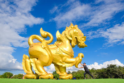 Low angle view of statue against sky