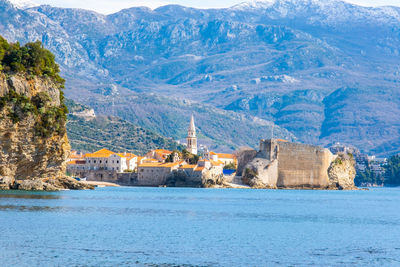 Scenic view of sea and mountains against sky