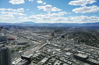 High angle view of cityscape against cloudy sky