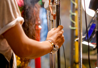 Cropped hand of woman holding pole