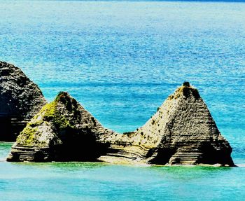 Scenic view of sea against rocks