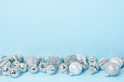 Christmas composition. silver decorations on pastel blue background