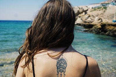 Rear view of woman at swimming pool