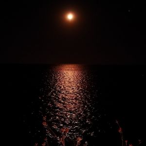 Scenic view of sea against sky at night