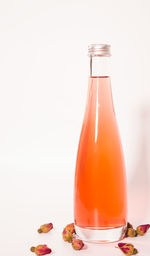 Close-up of drink in glass on table against white background