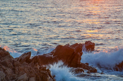 Waves splashing on rocks at shore