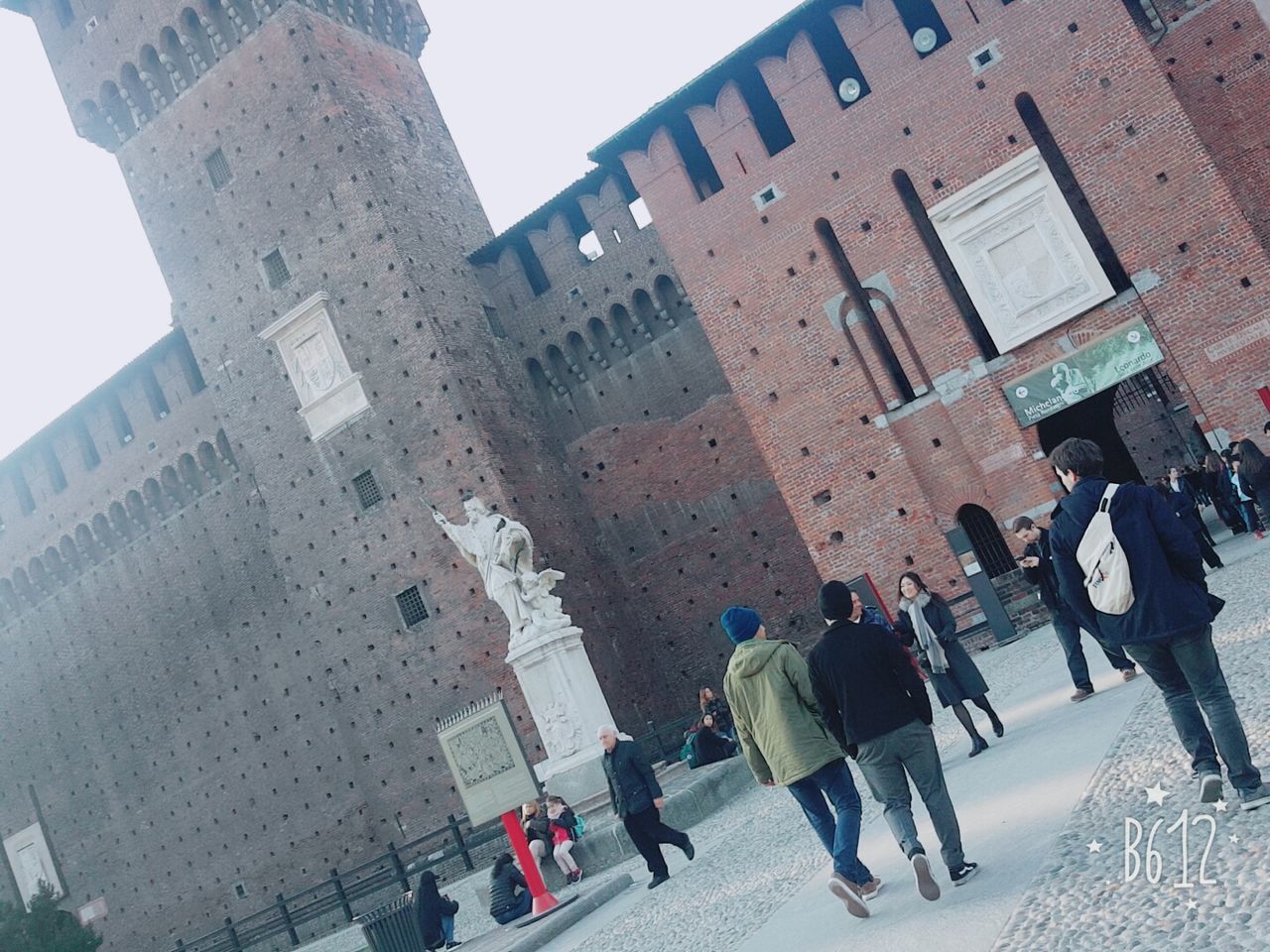 PEOPLE WALKING ON ROAD IN CITY