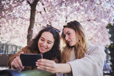 Smiling young women taking selfie