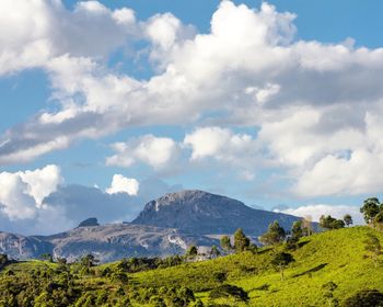 Scenic view of mountains against cloudy sky