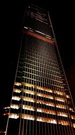 Low angle view of illuminated building against sky at night