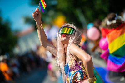 Low angle view of woman wearing sunglasses at music concert