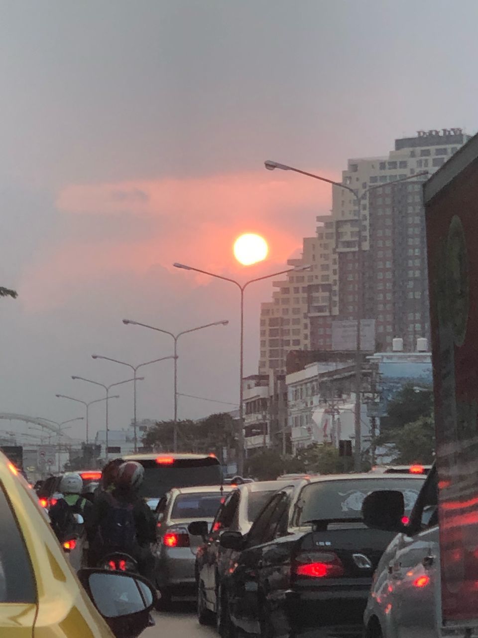 TRAFFIC ON ROAD IN CITY AT SUNSET