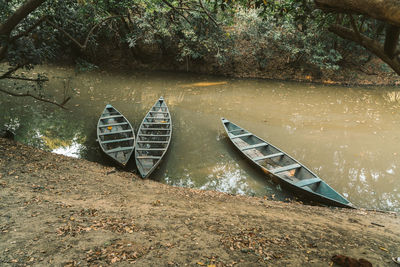 Abandoned boat moored on shore