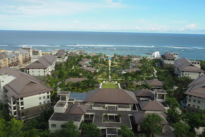 High angle view of townscape by sea against sky