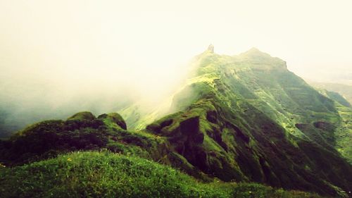 Scenic view of mountains against cloudy sky