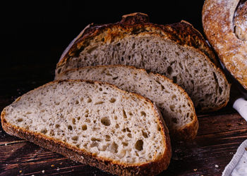 Close-up of bread on table against black background