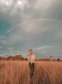 Man standing on field against sky