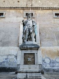 Low angle view of statue against wall