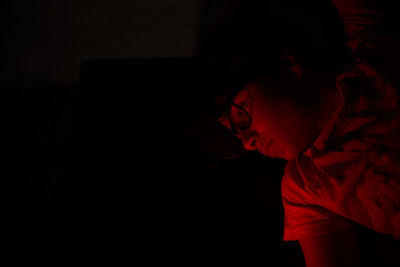 Thoughtful boy against black background