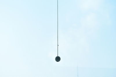 Low angle view of electric lamp against blue sky