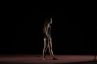 Full length of woman standing by railing