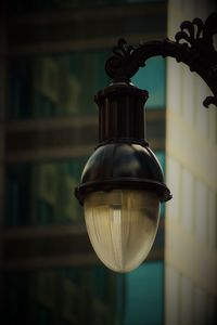 Low angle view of light bulb hanging at home