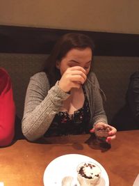 Close-up of woman eating food at home