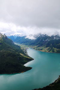 Scenic view of fjord and mountains against sky