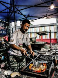 Man preparing food at market