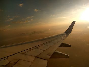 Airplane wing against sky