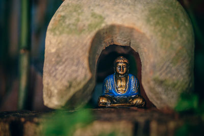 Close-up of buddha statue against building