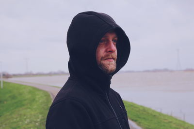 Man standing on field against sky