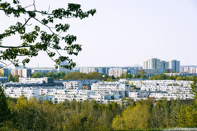 Buildings in city against clear sky