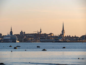 View of buildings in city against sky during sunset