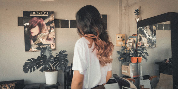 Rear view of woman standing at home