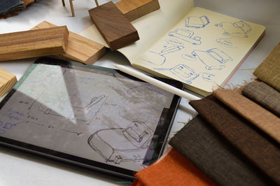 Furniture design, digital drawing in tablet and analog in notebook
