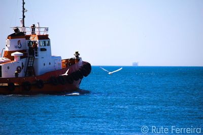 Ship in sea against clear sky