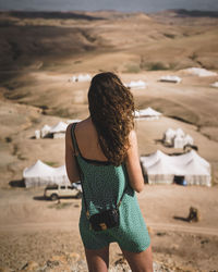 Rear view of woman standing in desert