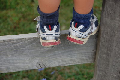 Midsection of child climbing a fence