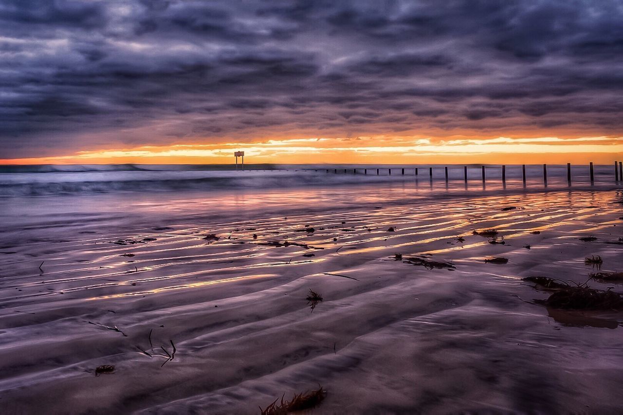 SCENIC VIEW OF BEACH DURING SUNSET