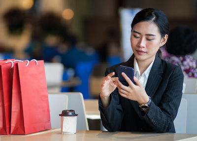 Mid adult woman using mobile phone