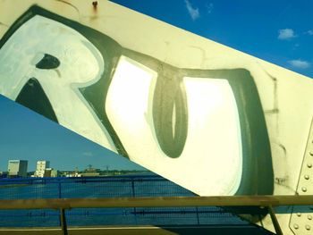 Low angle view of text on railing against building