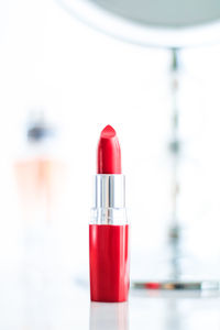 Close-up of red lipstick against white background