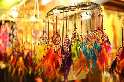 Close-up of illuminated lanterns hanging at market stall