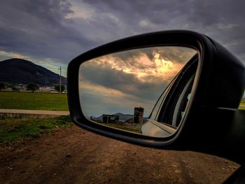 Reflection of road on side-view mirror of car